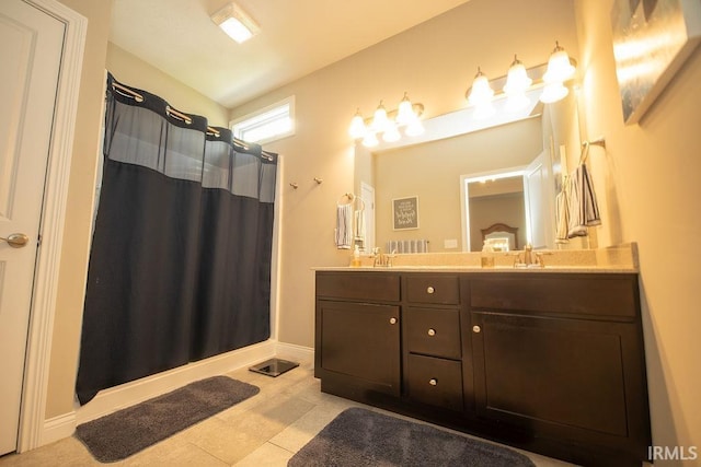 3417 S Tulip Ave, Bloomington, IN 47403 - full bathroom featuring double vanity, a shower with curtain, tile patterned floors, and baseboards