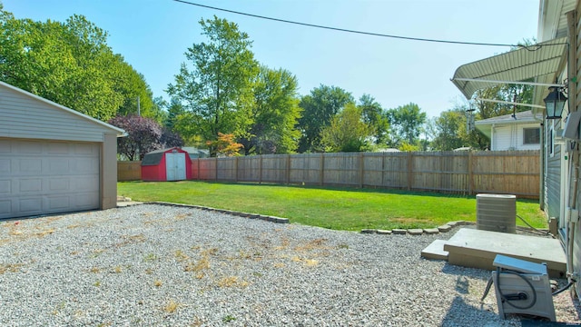 208 S Ohio St, Chandler, IN 47610 - view of yard with an outbuilding, central air condition unit, a storage shed, gravel driveway, and a garage