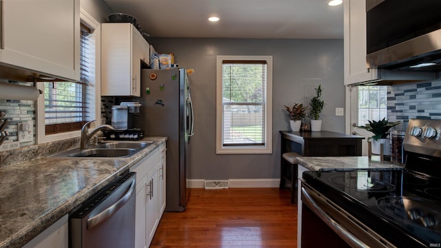 208 S Ohio St, Chandler, IN 47610 - kitchen featuring stainless steel appliances, a sink, white cabinetry, backsplash, and wood-type flooring