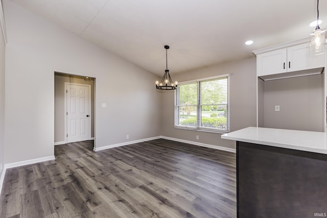 unfurnished dining area featuring dark wood-style flooring, baseboards, a chandelier, vaulted ceiling, and recessed lighting