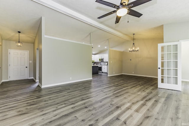 unfurnished living room featuring wood finished floors, a chandelier, baseboards, and a ceiling fan