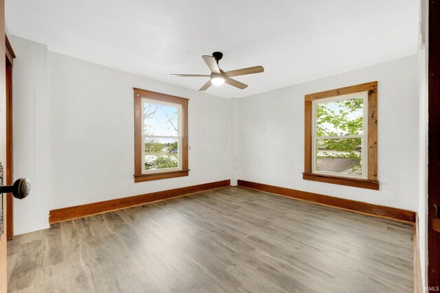 3910 E Bellefontaine Rd, Hamilton, IN 46742 - empty room with healthy amount of natural light, wood finished floors, and baseboards