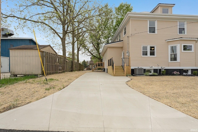 3910 E Bellefontaine Rd, Hamilton, IN 46742 - view of property exterior with central AC unit, driveway, an outbuilding, and a shed