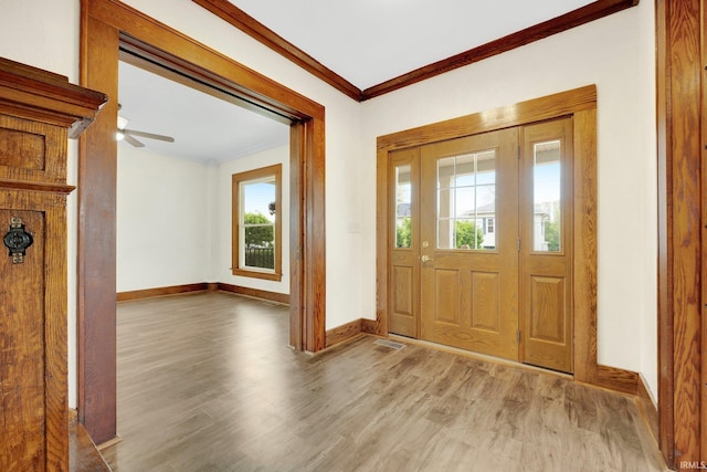 3910 E Bellefontaine Rd, Hamilton, IN 46742 - foyer entrance featuring crown molding, wood finished floors, baseboards, and a ceiling fan