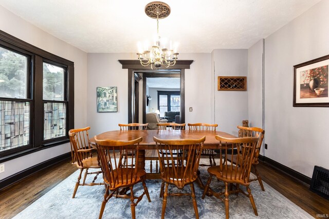 1026 N Michigan St, South Bend, IN 46617 - dining room featuring wood finished floors, a chandelier, and baseboards