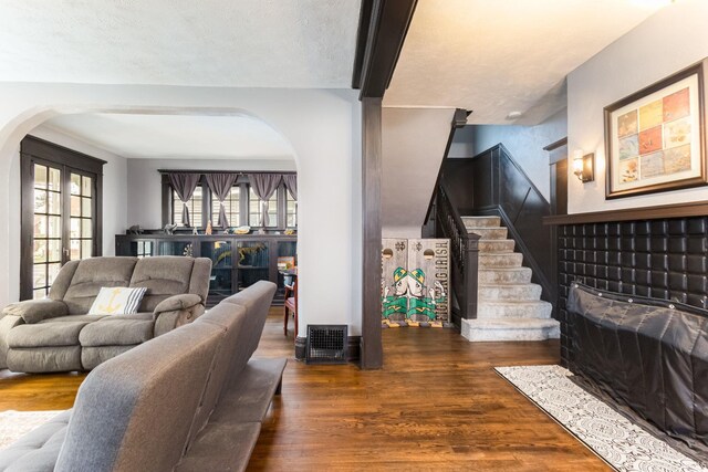 1026 N Michigan St, South Bend, IN 46617 - living room featuring arched walkways, wood finished floors, and stairway