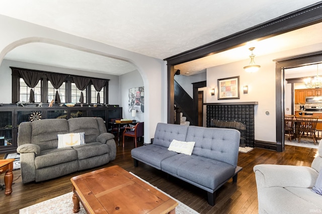 1026 N Michigan St, South Bend, IN 46617 - living area featuring arched walkways, wood finished floors, stairs, and baseboards