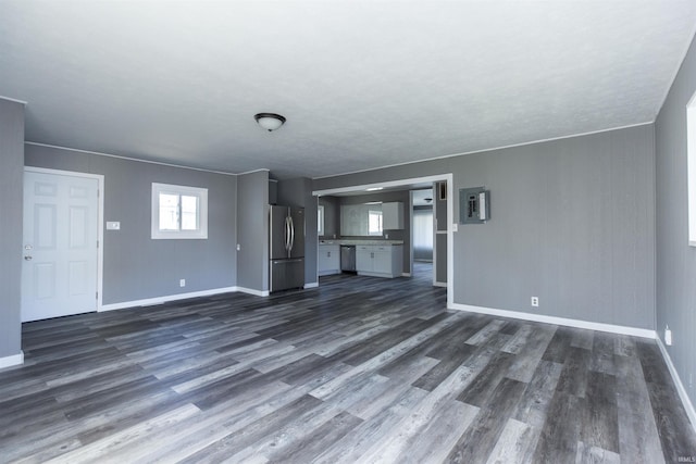 unfurnished living room featuring dark wood-style floors and baseboards