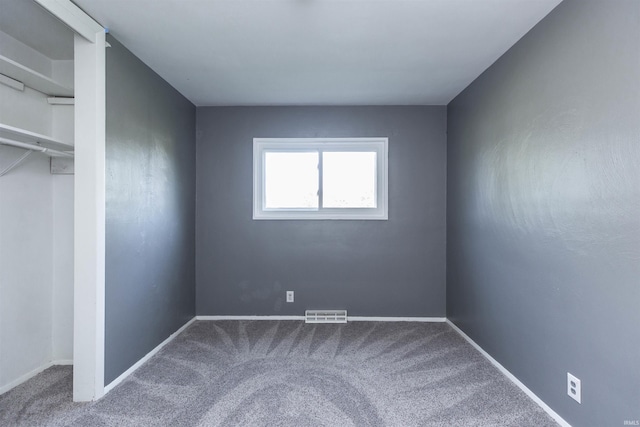 unfurnished bedroom with carpet, baseboards, and a closet