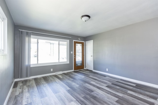 foyer entrance featuring wood finished floors and baseboards
