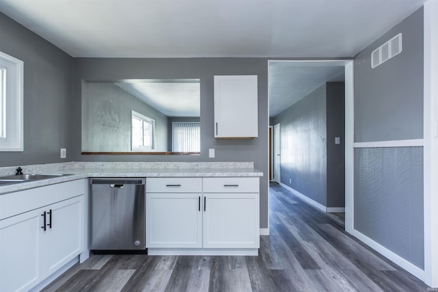 kitchen with dishwasher, white cabinetry, light countertops, and dark wood-style flooring