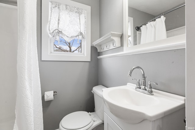 full bathroom with toilet and vanity