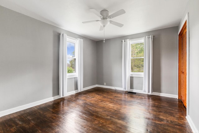 spare room featuring hardwood / wood-style flooring, ceiling fan, and baseboards