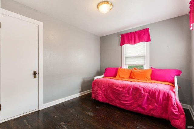 bedroom featuring hardwood / wood-style flooring and baseboards