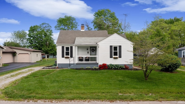 view of front facade featuring a chimney, an outbuilding, a front lawn, roof with shingles, and a detached garage