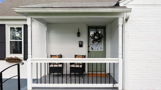 doorway to property featuring a shingled roof