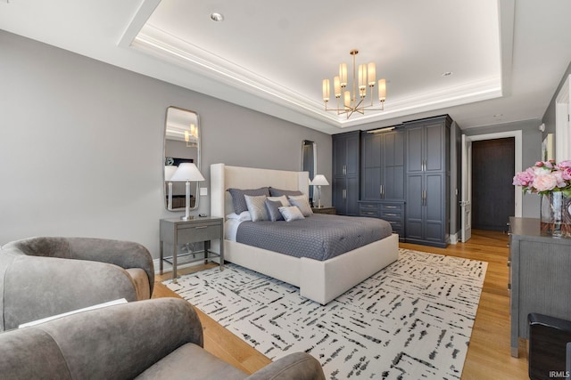 202 W Berry St Unit 810, Fort Wayne, IN 46802 - bedroom with a raised ceiling, a chandelier, and light wood-style flooring