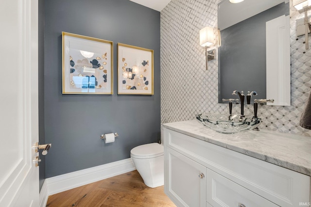 202 W Berry St Unit 810, Fort Wayne, IN 46802 - bathroom with toilet, baseboards, vanity, and wood finished floors