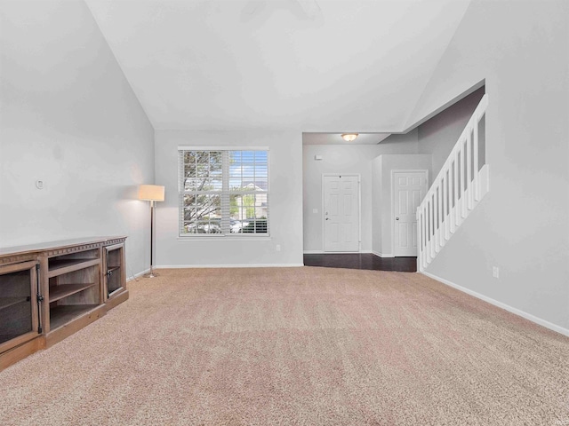 11515 Ballycastle Pl, Fort Wayne, IN 46818 - unfurnished living room featuring lofted ceiling, carpet flooring, stairway, and baseboards