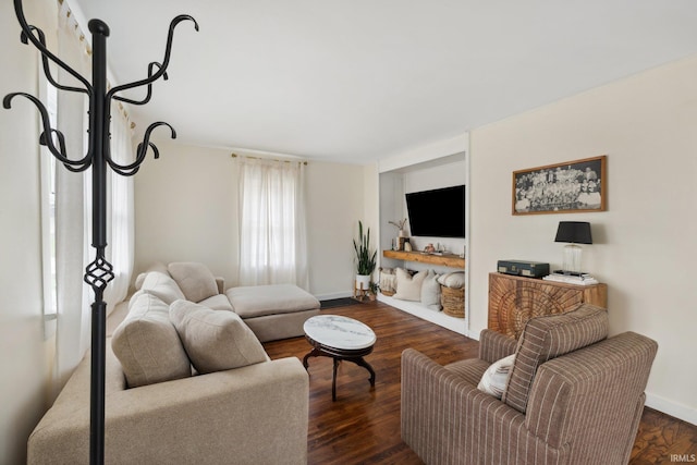 living room featuring baseboards and dark wood-style flooring