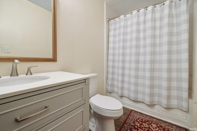 full bath with vanity, toilet, shower / tub combo with curtain, and wood finished floors