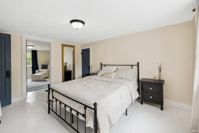 bedroom with baseboards, light wood-style floors, and a closet