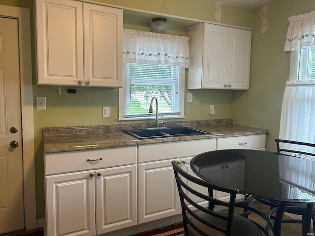2705 Edgar St, Evansville, IN 47710 - kitchen with a sink, white cabinets, and plenty of natural light