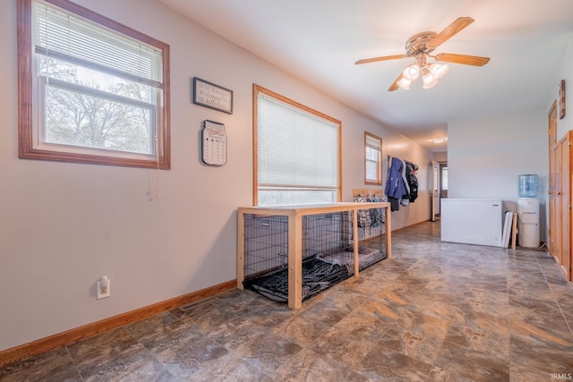 521 S Riverside Dr, Winamac, IN 46996 - hall with plenty of natural light, baseboards, and stone finish floors