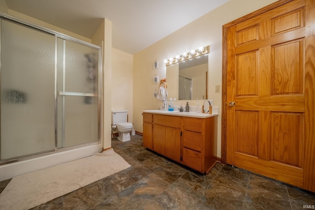 521 S Riverside Dr, Winamac, IN 46996 - full bath with a stall shower, stone finish floors, toilet, and vanity