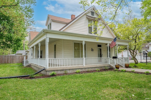 521 S Riverside Dr, Winamac, IN 46996 - country-style home with covered porch, a chimney, and a shingled roof