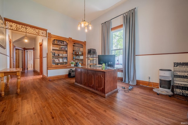521 S Riverside Dr, Winamac, IN 46996 - office with wood finished floors, a chandelier, and baseboards