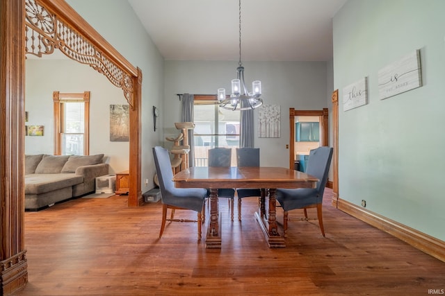 521 S Riverside Dr, Winamac, IN 46996 - dining room with a chandelier, wood finished floors, and baseboards