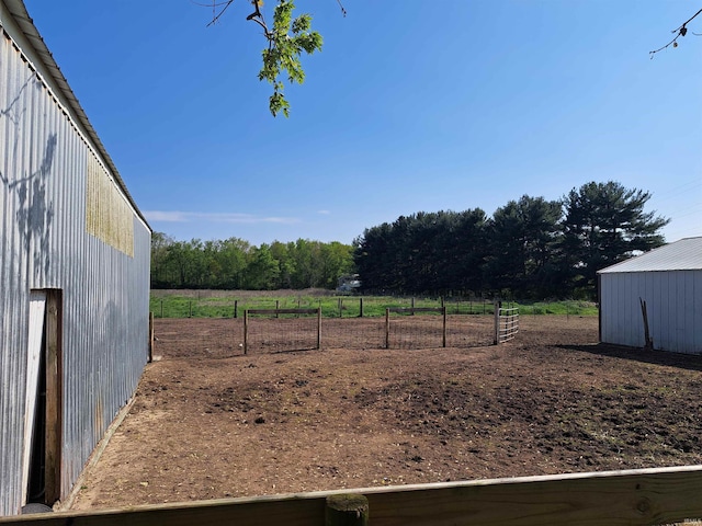 view of yard with a view of countryside, a pole building, and an outdoor structure