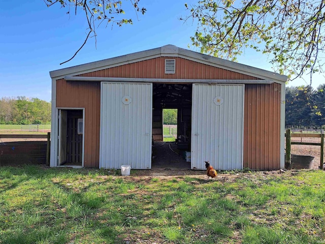 view of pole building featuring fence