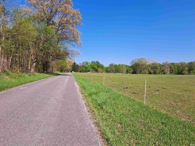 view of asphalt street with a view of rural / pastoral area
