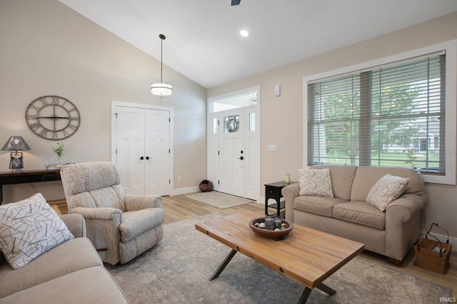 104 Lavender Ct, New Carlisle, IN 46552 - living room with light wood-style floors, baseboards, high vaulted ceiling, and recessed lighting