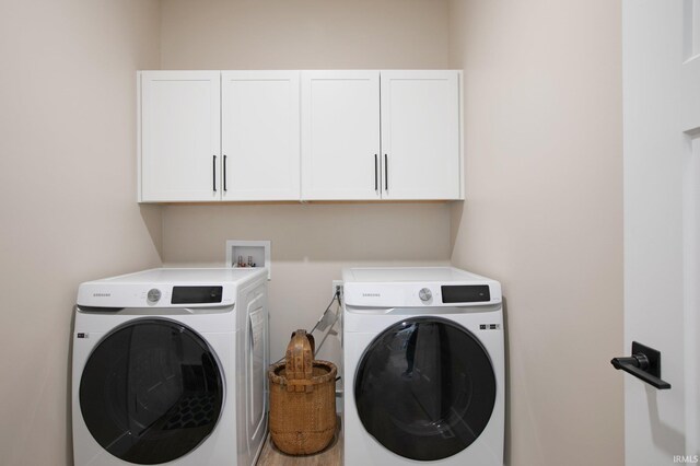 104 Lavender Ct, New Carlisle, IN 46552 - clothes washing area featuring cabinet space and separate washer and dryer