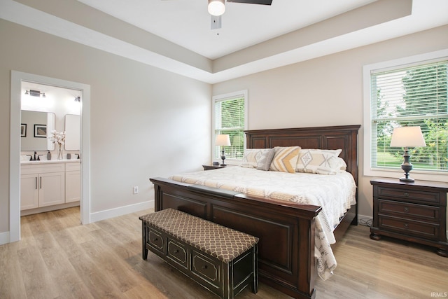 104 Lavender Ct, New Carlisle, IN 46552 - bedroom featuring light wood finished floors, baseboards, connected bathroom, and ceiling fan