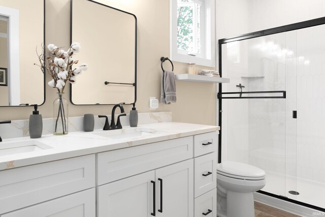 104 Lavender Ct, New Carlisle, IN 46552 - bathroom featuring a shower stall, toilet, and double vanity