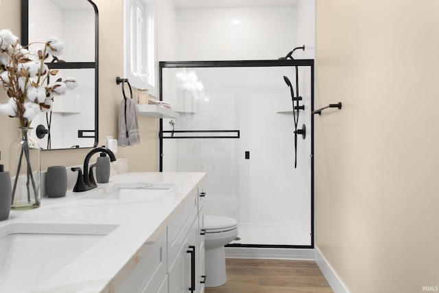 104 Lavender Ct, New Carlisle, IN 46552 - full bathroom with a stall shower, toilet, wood finished floors, and double vanity