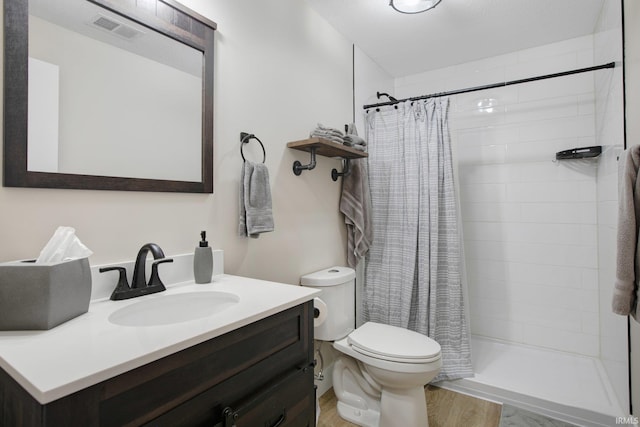 104 Lavender Ct, New Carlisle, IN 46552 - bathroom featuring toilet, wood finished floors, a shower stall, and vanity