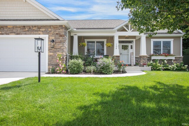 104 Lavender Ct, New Carlisle, IN 46552 - craftsman inspired home with stone siding, a front lawn, and an attached garage