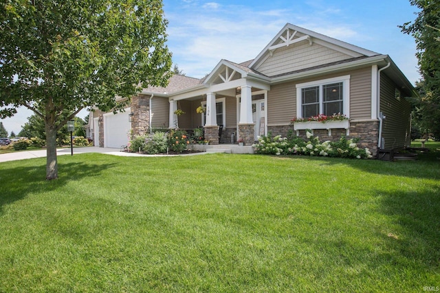 104 Lavender Ct, New Carlisle, IN 46552 - craftsman inspired home with stone siding, a porch, an attached garage, and driveway