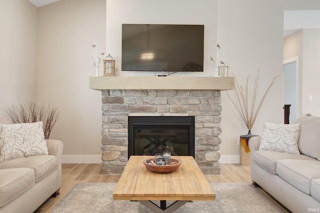 104 Lavender Ct, New Carlisle, IN 46552 - living room with wood finished floors, baseboards, and a stone fireplace