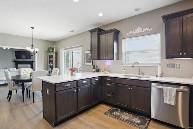 kitchen featuring dishwasher, a sink, light wood-style flooring, healthy amount of natural light, and recessed lighting