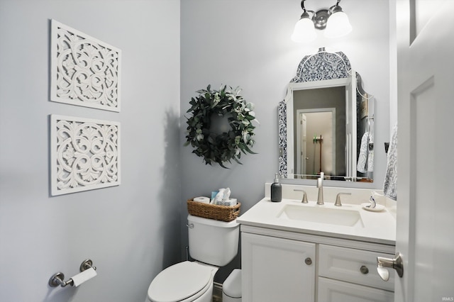 half bath featuring toilet and vanity