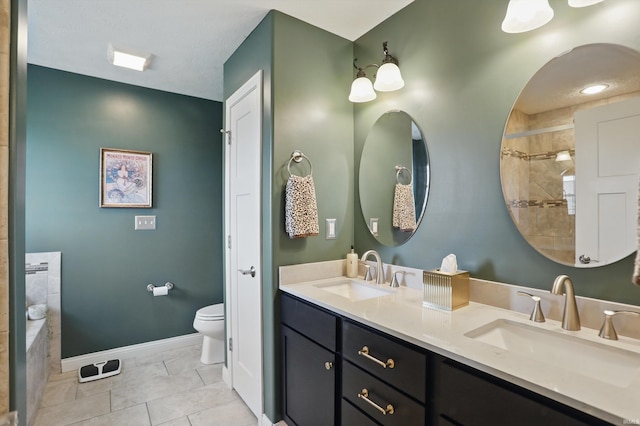 bathroom with toilet, double vanity, baseboards, tile patterned flooring, and a tile shower