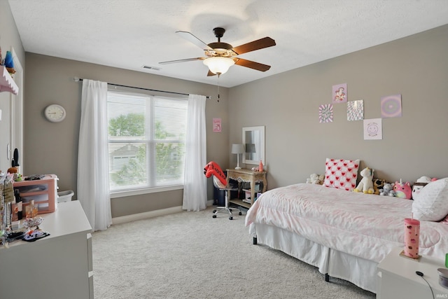 bedroom featuring light colored carpet, baseboards, and a ceiling fan