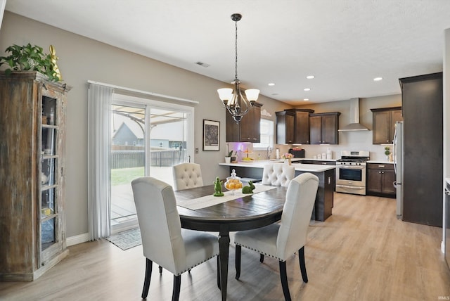 dining room featuring light wood-style flooring, recessed lighting, a chandelier, and baseboards