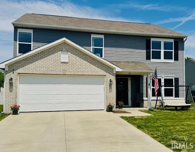 384 Ariel Dr, Kokomo, IN 46901 - view of front facade with concrete driveway, a front yard, and a garage